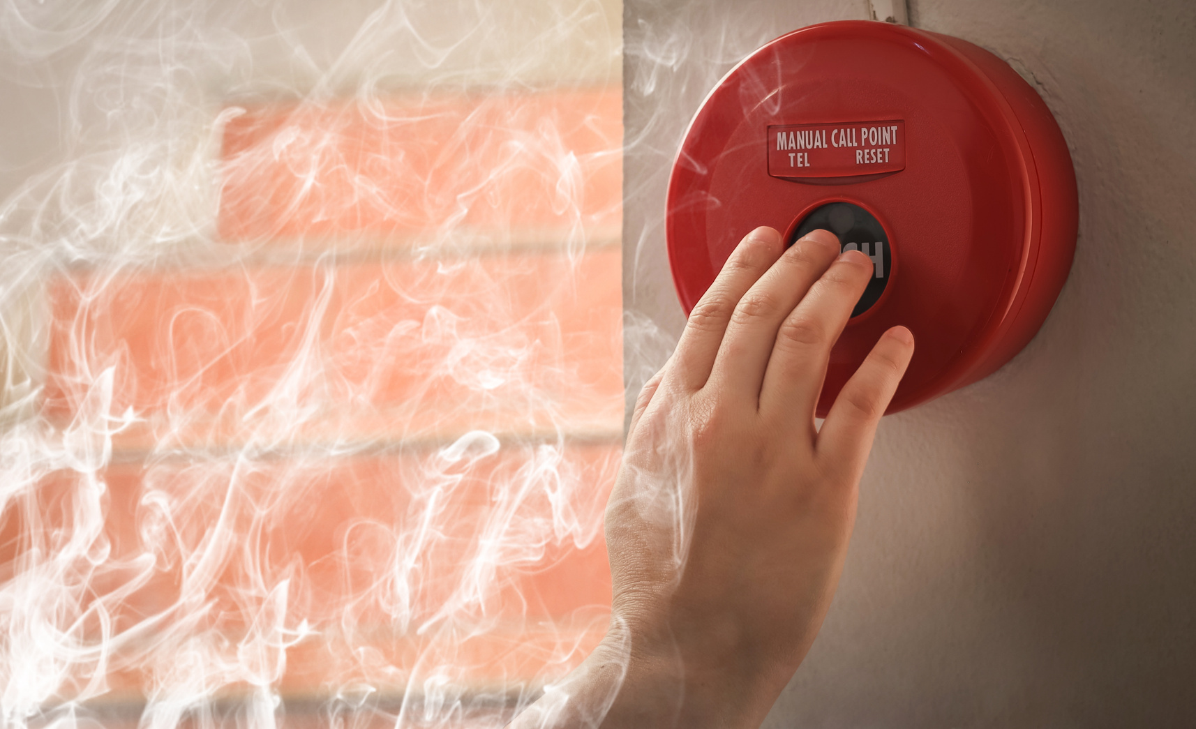Foreman or worker pushing fire alarm on the wall. A fire! or Emergency case at the factory building. Emergency of Fire alarm or alert or bell warning equipment